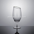 Slanted tumbler glass with gold rim